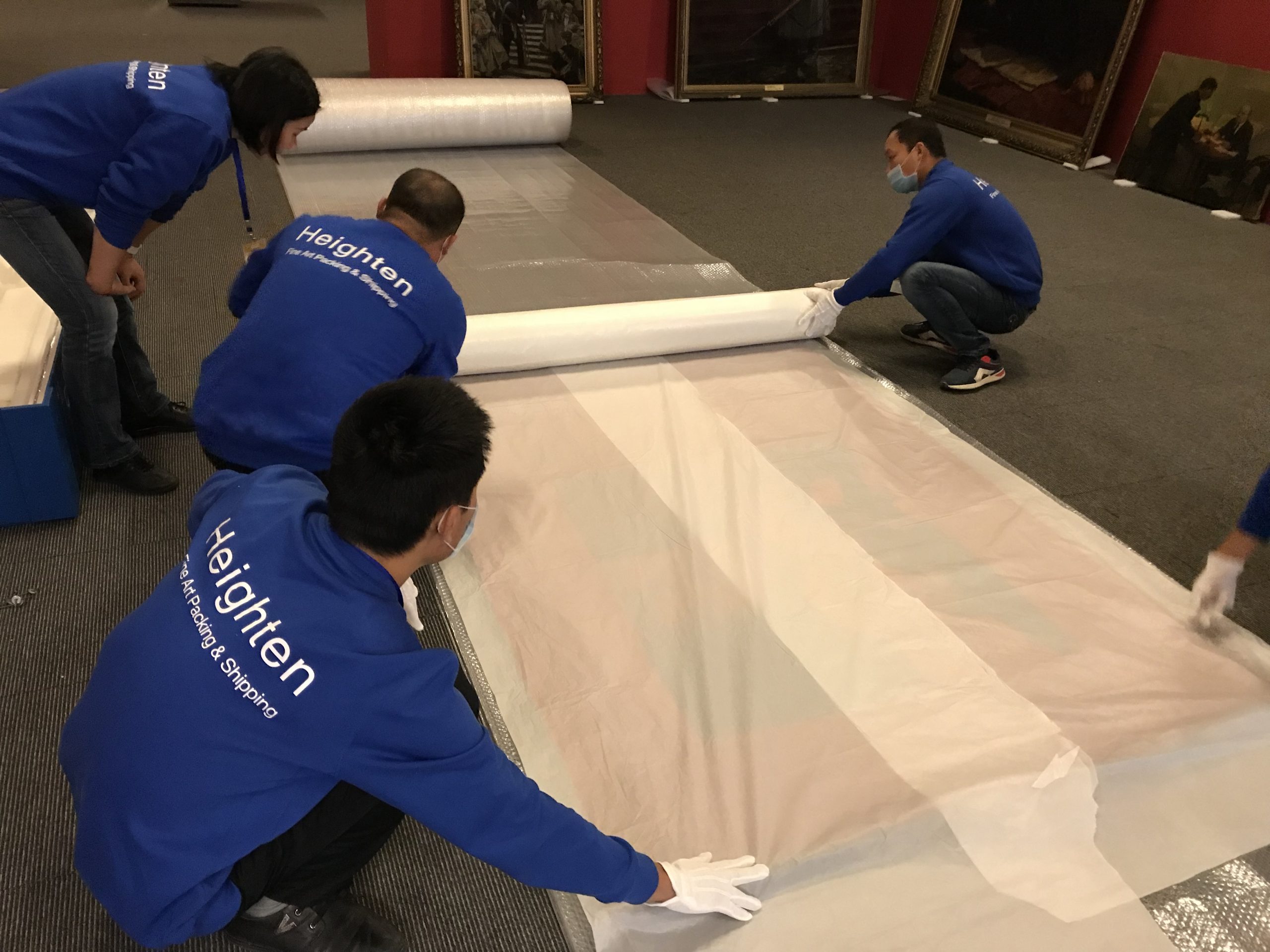 The Heighten team laying protective sheeting in a gallery