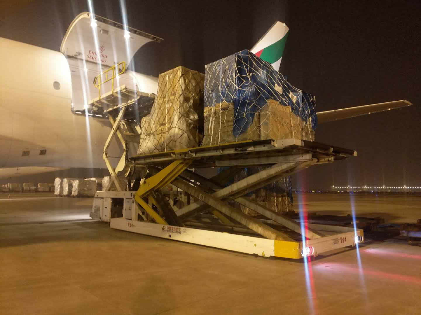 Air cargo being loaded at night