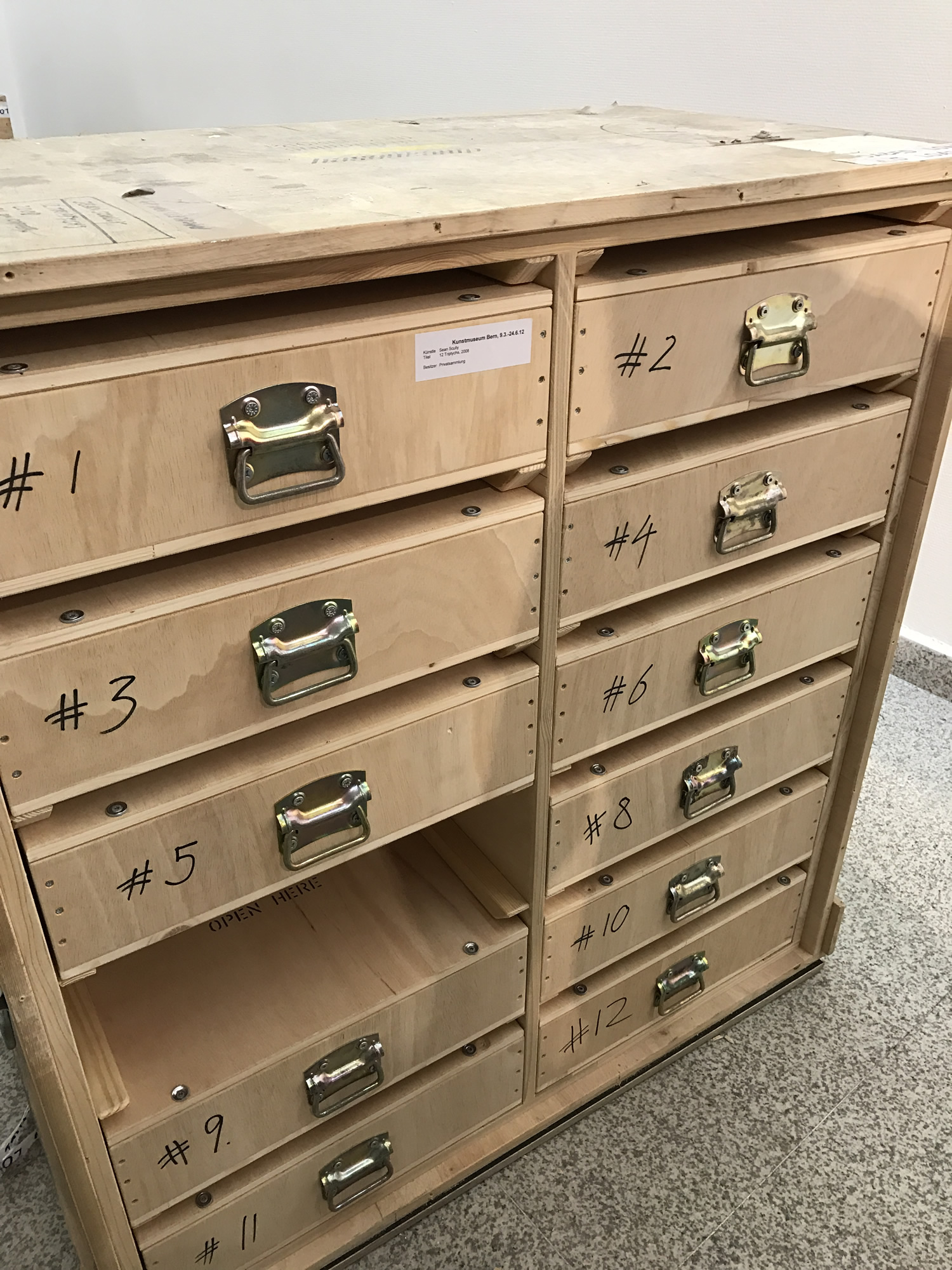 A cabinet of numbered drawer crates